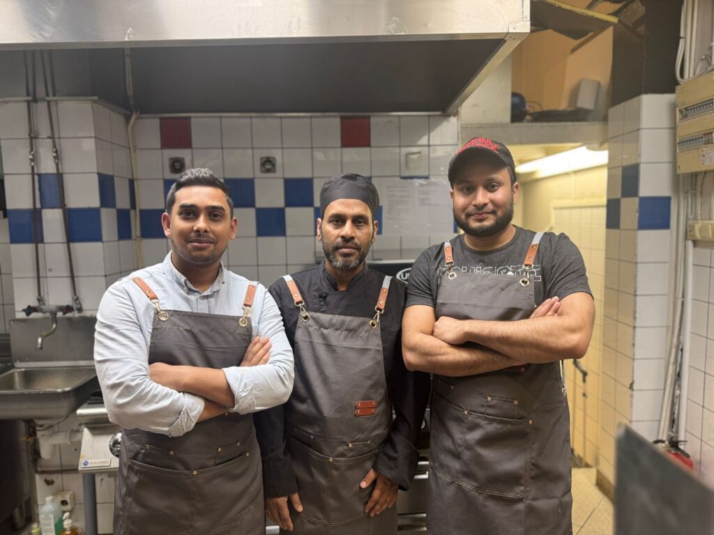 Three Chefs in a kitchen standing